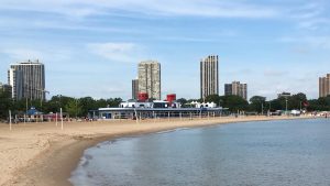 beach with people playing volleyball and skyline at the back